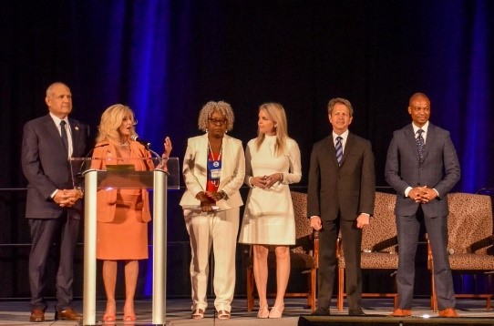 Commissioner Sachs on stage at the summit