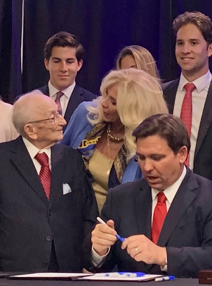 Commissioner Sachs at medal presentation with Ben Ferencz and Governor DeSantis