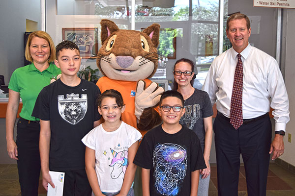 kids and adults smiling with oakly department mascot