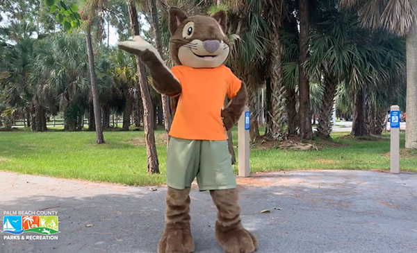 oakly department mascot waving in park